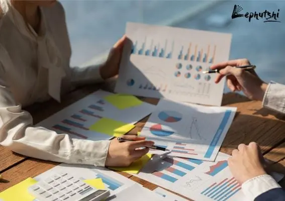 Business Plan Basics: Botswana Template & Guide 5 Two professionals analyzing market data with graphs and charts for a Botswana business plan