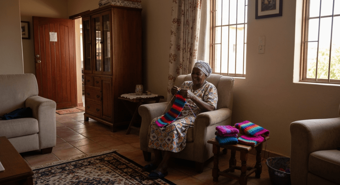 Retiree knitting as a part of a hobby-based business in Botswana